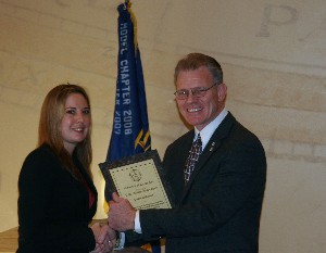 In December, Mark Witzel, chapter president, presents a corporate plaque to Nicole M. Fellouris, chief executive officer of Elite Development Group, a new corporate member.